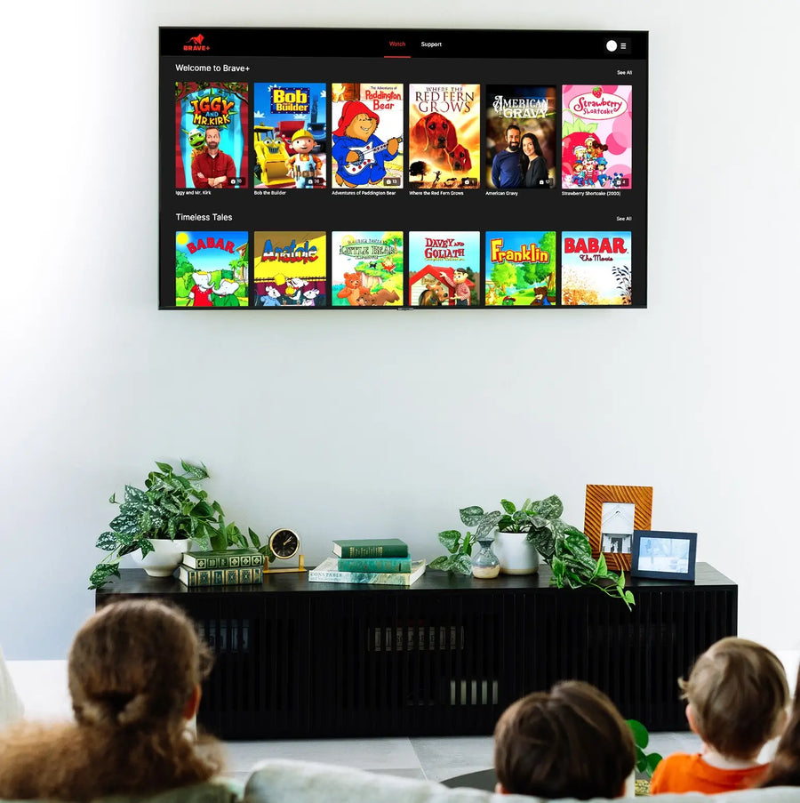 Children watching a screen displaying animated shows in a living room.