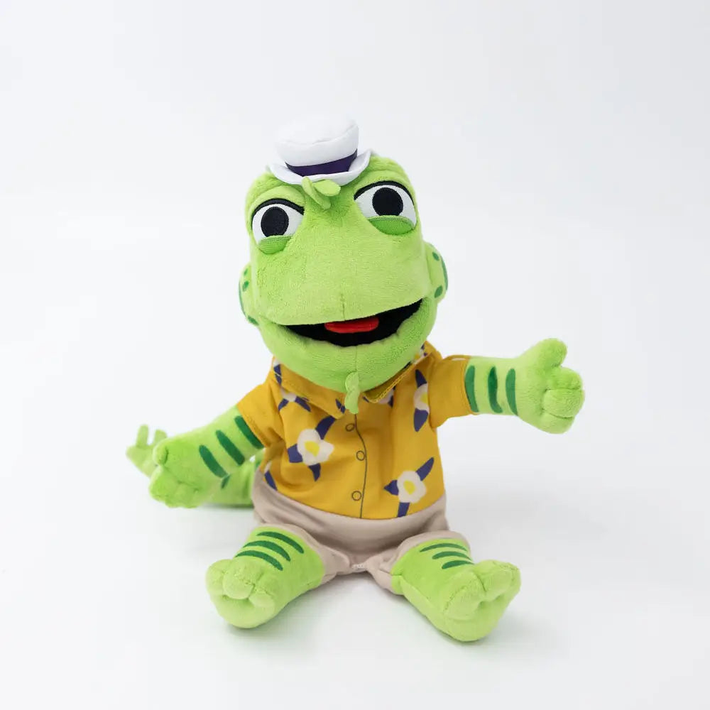 Plush toy frog wearing a yellow shirt with a white background