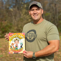 Kentucky Ballistics is holding a book titled 'BOOM! POW! I'm Braver Now!' outdoors