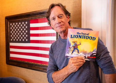 Kevin Sorbo holding his children's book "The Test of Lionhood" by BRAVE Books