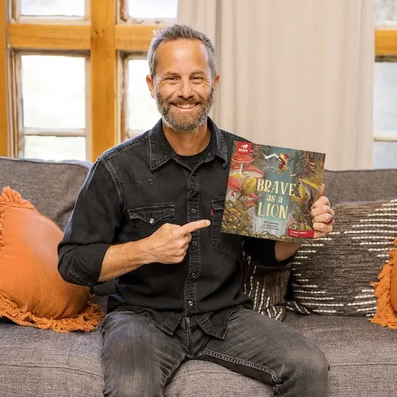 Kirk Cameron smiling with his children's book BRAVE as a Lion