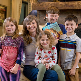 Missy Robertson with her family and her children's book, Because You're My Family