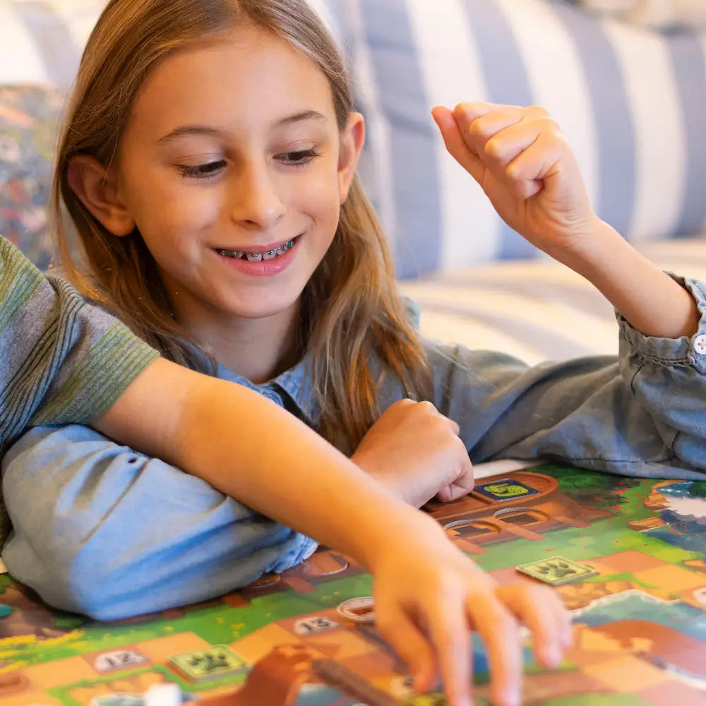 Little girl playing Brave Books Beat the Flood board game