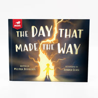 Book cover of 'The Day That Made the Way' with a child standing in a beam of light.
