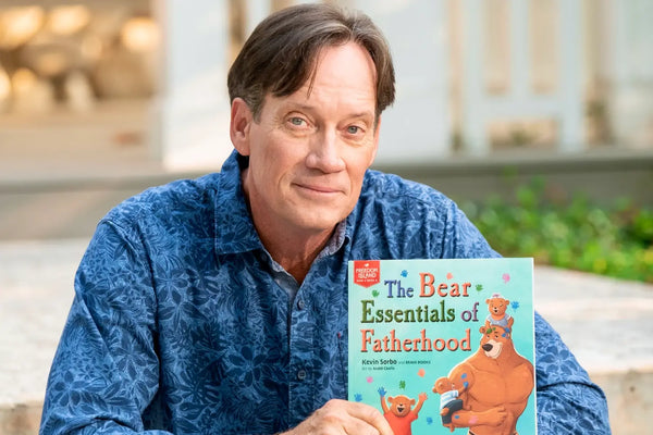 Kevin Sorbo holding his children's book, The Bear Essentials by BRAVE Books