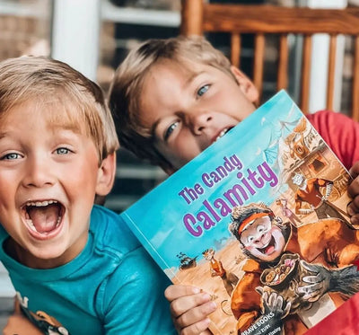 Little boys smiling with a Brave Books book