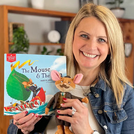 Heidi St. John holding her BRAVE Books book, The Mouse and the Sea as well as a plush Mr. Mouse