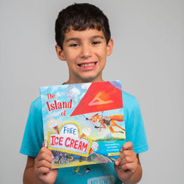 Little boy holding Brave Books, The Island of Free Ice Cream by Jack Posobiec