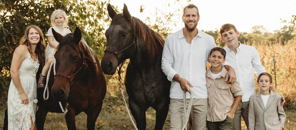 Family with horses in a natural setting